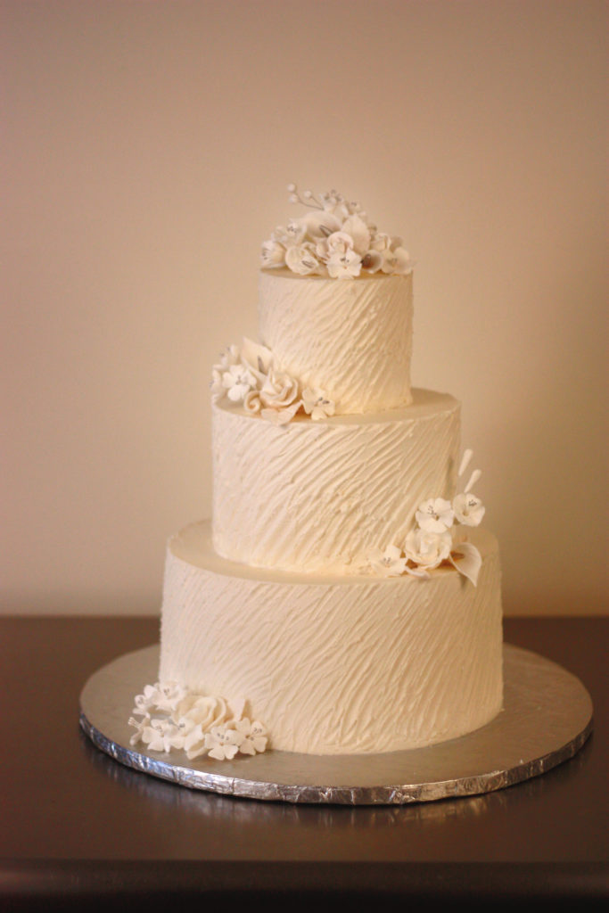 Buttercream Wedding Cake angled texture with hand sculpted sugar flowers by Donna Joy