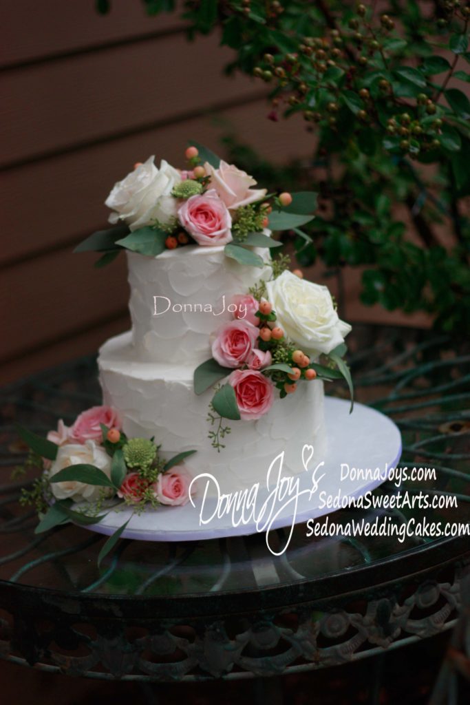 tuscan waves wedding cake adorned with fresh flowers