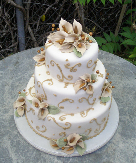 Champagne Delight, Champagne swirls, hand sculpted sugar calla lilies and berries adorn this one