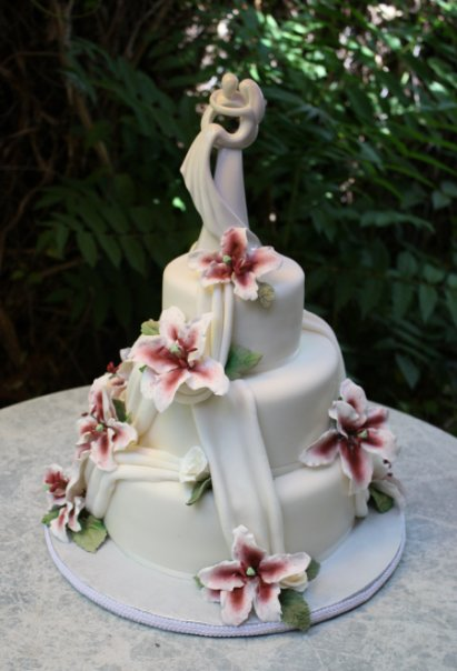 Burgundy Love Wedding cake- Three tier round fondant wedding cake with fondant drapes laced ruffled hand sculpted pastillage sugar lilies and texture green sugar leaves by Donna Joy ♥