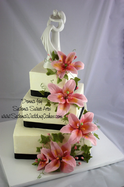 Sweet pink sugar lilies, ivy and berries. Hand sculpted petal by petal by Donna Joy. Adorning this square offset buttercream cake.