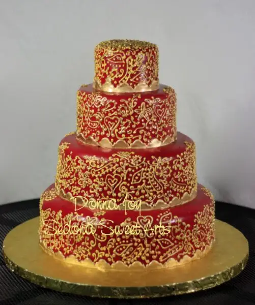 Original Custom Cake design by Donna Joy. Gold on red fondant.