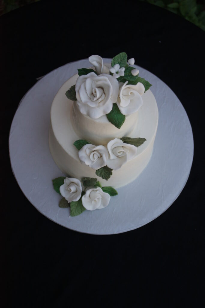 White Hand Sculpted Sugar Roses on a smooth Buttercream Wedding Cake