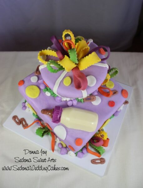 Baby cake. Wacky, offset, colorful. 2010 with a whimsical bow White chocolate baby bottle