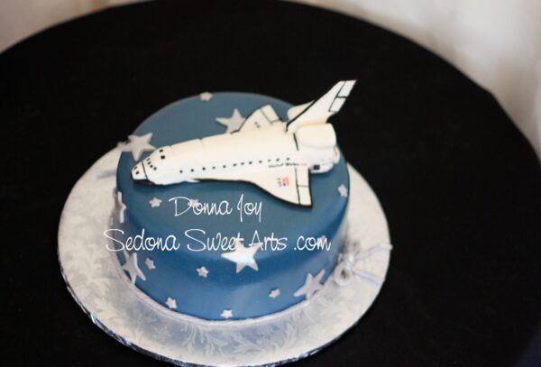 Hand sculpted space Shuttle cake on a cake