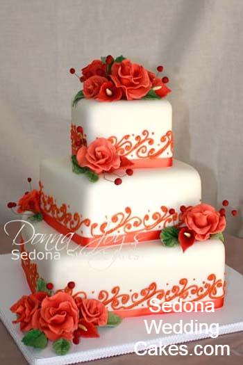 Sedona Wedding Cakes by Pastry Chef Donna Joy. three tier wedding cake is adorned with hand sculpted sugar flowers custom colored