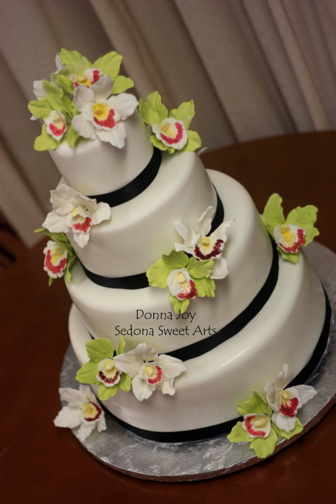 Fondant cake adorned with extraordinary sugar orchids-flowers hand sculpted by Donna Joy